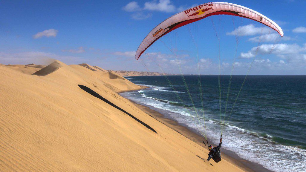 paragliding-over-sand-dunes-in-n-1024x576